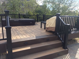 Wooden deck with spa leading down to path. 